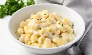 Pyszny makaron z kremowym sosem serowym, posypany natką pietruszki. Idealny sos do makaronu na szybki obiad.