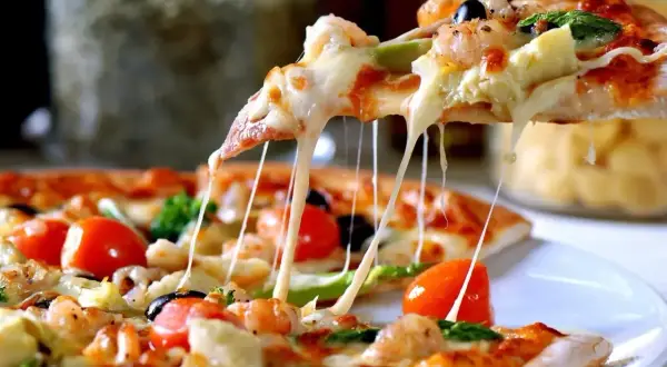 Rozciągający się ser z ciasta na pizzę z krewetkami, pomidorkami i oliwkami. Idealne na wspólny wieczór.